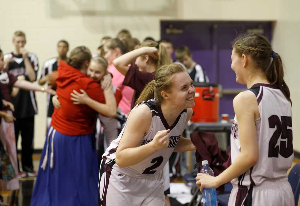 Photo by Rashah McChesney/Peninsula Clarion Nikolaevsk Warrior Kilina Klaich reacts with Megan Hickman after their win against the Cook Inlet Academy Eagles Friday March 7, 2014 at Skyview High School in Soldotna, Alaska.  The Warriors will advance to the small school state championship as the result of the game.