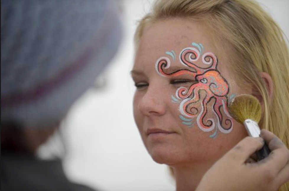 Photo by Rashah McChesney/Peninsula Clarion Danielle Rickard, of Ninilchik, gets an octopus painted on her face Friday August 2, 2013 during Salmonstock in Ninilchik, Alaska.