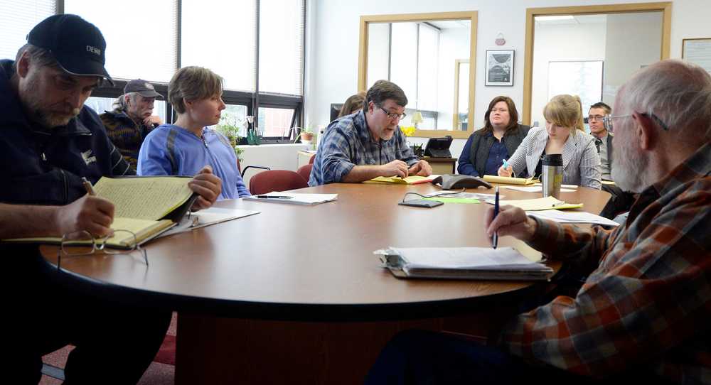 Photo by Dan Balmer/Peninsula Clarion Clark Whitney of Kenai gives his two-minute testimony telephonically to the Senate Resource Committee in opposition to House Bill 77 at the Legislative Information Office in Kenai Wednesday. Approximately 25 people packed the Kenai office to give testimony but only three were heard by the committee as they heard from residents all over the state. More than 40 people commented in the 90 minute period with only two people in support of the amended bill.