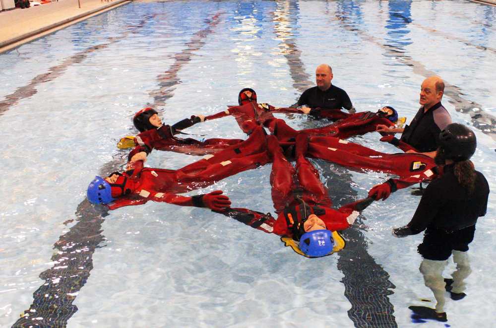 Students of the inagural Survival 101 spring break camp at the Challenger Center in Kenai learn how to make safety formations to conserve energy when stuck floating in cold water. Photo by Kelly Sullivan/ Peninsula Clarion