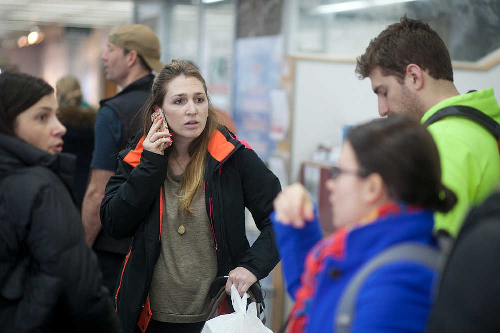 Photo by Rashah McChesney/Peninsula Clarion  One of several passengers in a group headed to Anchorage talks about obtaining a refund from United Airlines after flight 1425 was diverted to the Kenai Municipal Airport Friday and passengers were stranded for about 18 hours in Kenai, Alaska.  More than 100 passengers, many of whom slept on the floor of the airport, were told their overnight stay was necessary as the pilot and flight crew had exceeded the hours the Federal Aviation Administration allows them to fly.