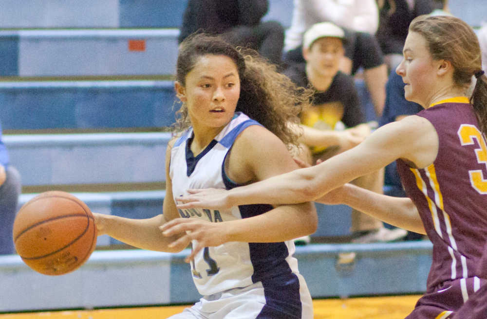 Photo by Rashah McChesney/Peninsula Clarion  Soldotna's Makayla Wong looks for an opening to pass during their game against Dimond Friday Jan. 17, 2014 in Soldotna, Alaska.