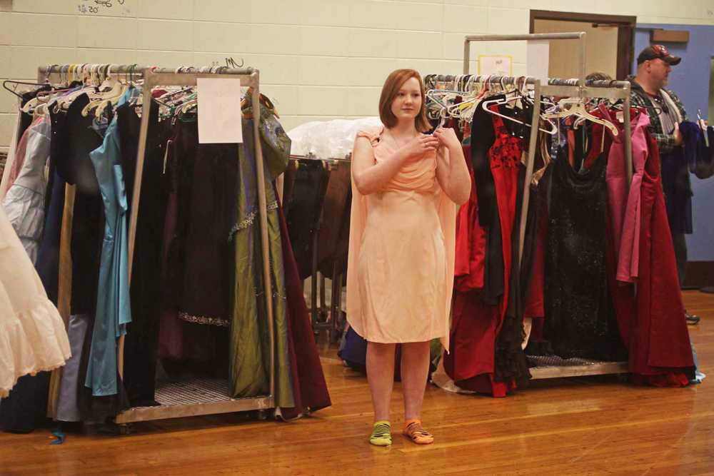 Photo by Kelly Sullivan/ Peninsula Clarion  "I think this is the perfect color for me," said Nicole Kreider after choosing her favorite dress, Tuesday, March 18, at Cinderellas Closet in Soldotna Highschool.