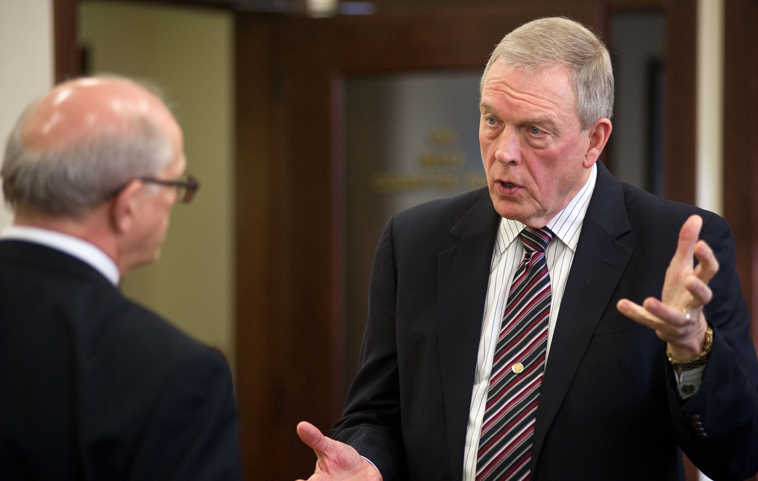 University of Alaska President Patrick Gamble, right, speaks to Sen. John Coghill, R-Fairbanks, who chairs the Senate Judiciary Committee, after public testimony on Senate Bill 176 at the Capitol in Juneau, Alaska, on Wednesday, March 5, 2014. Senate Bill 176, sponsored by Sen. Coghill, would prohibit the university from banning firearms or knifes on its campuses with the exception of restricted areas where visitors are screened. Gamble has spoken against the bill. (AP Photo/The Juneau Empire, Michael Penn  )