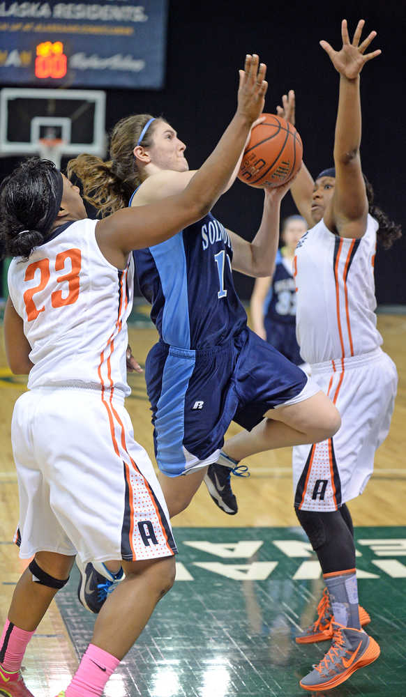 Soldotna's Julie Litchfield shoots against West's Marshal Eady (23) and Chamira Cockerham during their 4A girls state basketball tournament game on Thursday night at Anchorage's Sullivan Arena.