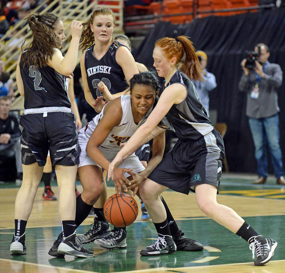 Nikiski's Hallie Riddall (2), Emily Lynch (22) and Chena Litzen defend Mt. Edgecumbe's Taryn White during their 3A girls state basketball game on Thursday at Anchorage's Sullivan Arena.