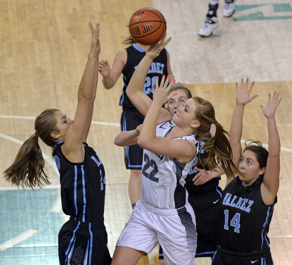Nikiski senior Emily Lynch (22) scores over Valdez sophomores Mesa Rohrer and Madison Fleming and senior Rachel MacDonald (14) during their 3A girls consolation bracket game in the ASAA state high school basketball tournament at Anchorage's Sullivan Arena on Friday.