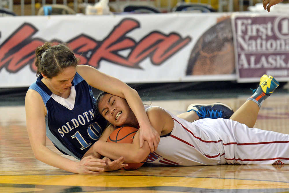 Soldotna High School senior Julie Litchfield (10) scraps for a loose ball with East sophomore Hannah Coffin during their 4A girls consolation bracket game in the ASAA state basketball tournament at Anchorage's Sullivan Arena on Friday.