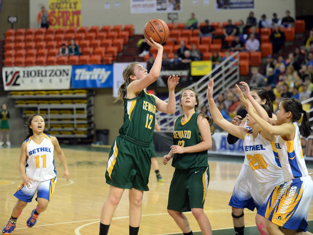 Seward High School junior Laura Kromrey scores against Bethel during their 3A girls consolation bracket game in the ASAA state basketball tournament at Anchorage's Sullivan Arena on Friday. Seward won 37-33. Seahawks teammate Maria Jackson (22) moves into the play.