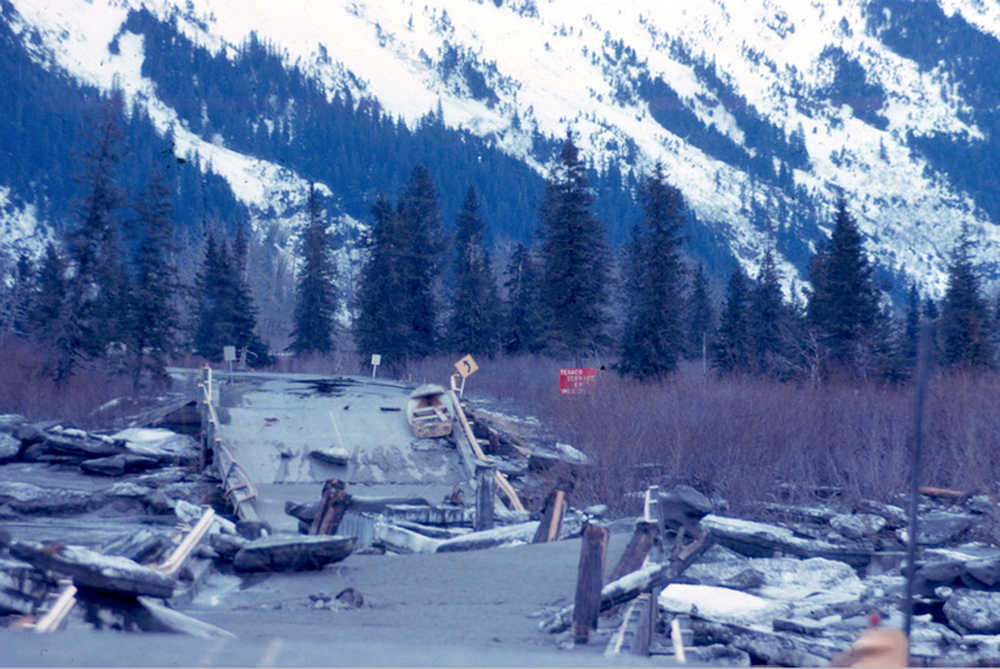 Alaska State Library,Alaska Earthquake Archives Committee, U.S. Army Photo,UAF-1972-153-350 The Seward Highway along Kenai Lake  on March 30, 1964 following the Alaska Earthquake and Tidal Wave. A view of cracked lake ice near Cooper Landing. The ground has collapsed beneath a length of railroad.