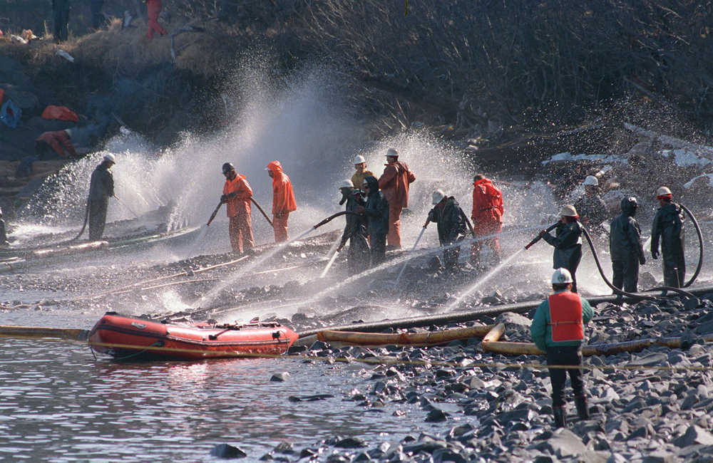 In this April 21, 1989 file photo, crews use high pressured hoses to blast the rocks on this beach front on Naked Island, Alaska. This is one of only two beaches that are being worked on, of the 58 beaches in the Prince William Sound.  On March 24, the crude oil tanker Exxon Valdez grounded on a reef and spilled nearly 11 million gallons of oil in the waters. Nearly 25 years after the Exxon Valdez oil spill off the coast of Alaska, some damage heals, some effects linger in Prince William Sound.  (AP Photo/Rob Stapleton, File)