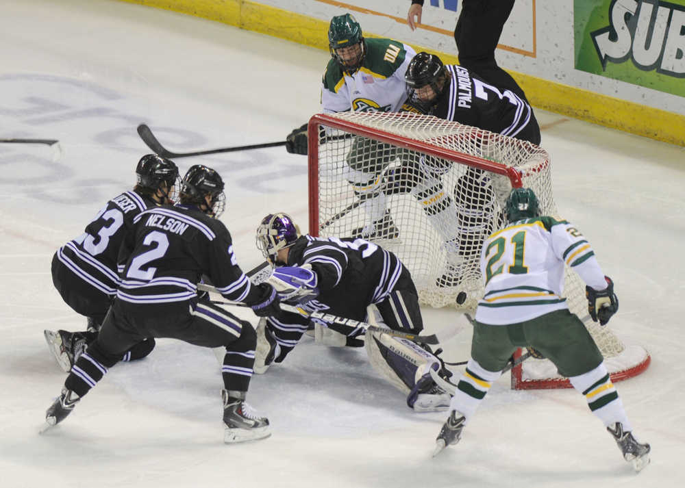 Brad Duwe of Univeristy of Alaska Anchorage, top, watches as his tapped puck lands in the net for his first goal of the year and a 1-0 lead over Minnesota State-Mankato during first-period action on Friday, Jan. 10, 2014, at Sullivan Arena in Anchorage, Alaska. (AP Photo/The Anchorage Daily News, Erik Hill)