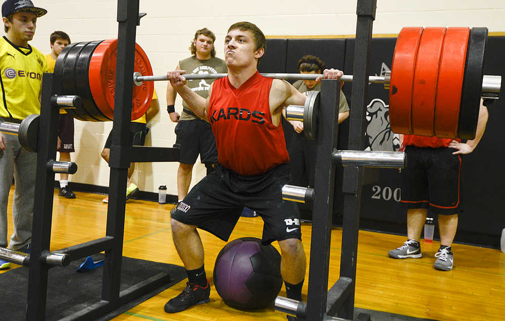 Photo by Rashah McChesney/Peninsula Clarion  Chase Logan, squats 385 pounds during a Speed Strength Training competition Thursday March 26, 2014 at Nikiski High School in Nikiski, Alaska.