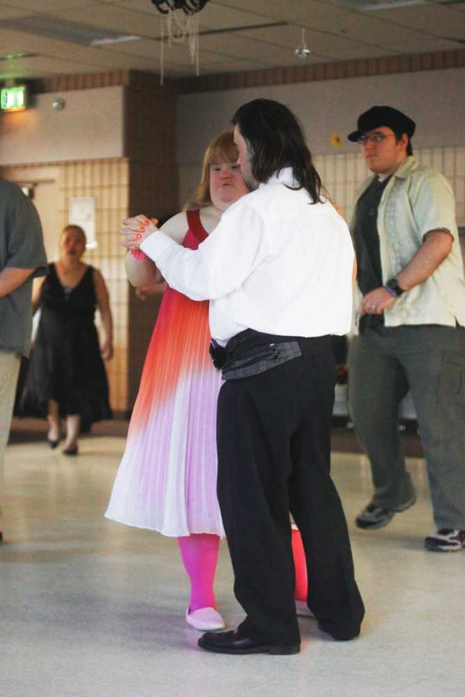 Photo by Kelly Sullivan/ Peninsula Clarion Wife and husband, Samantha Romig and Joe Romig, slow dance at the fifth annual Spring Fling, Friday, March 28, at the Soldotna Sports Center.