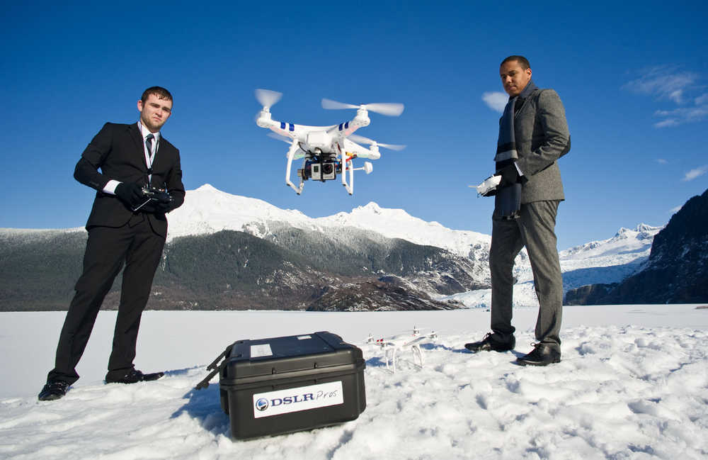 Chris Carson, left, and Lion El Aton of Firefight Films demonstrate their DJI Phantom drone quadcopter at Mendenhall Lake in Juneau, Alaska, on Thursday, March 20, 2014. They have been using the unit to film the glacier and an ice cave this winter. (AP Photo/Juneau Empire, Michael Penn)