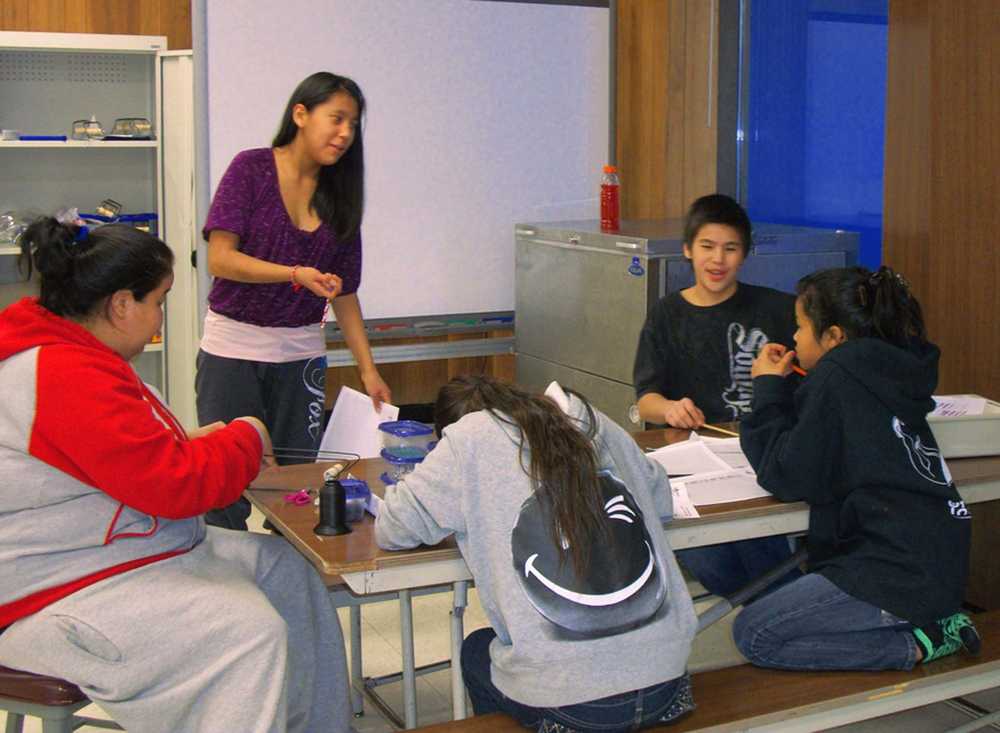 Photo courtesy by Bonnie Pierce/ Project GRAD Trinity Standifer working with her Native Youth Olympics team on a fundraiser, in Tyonek.