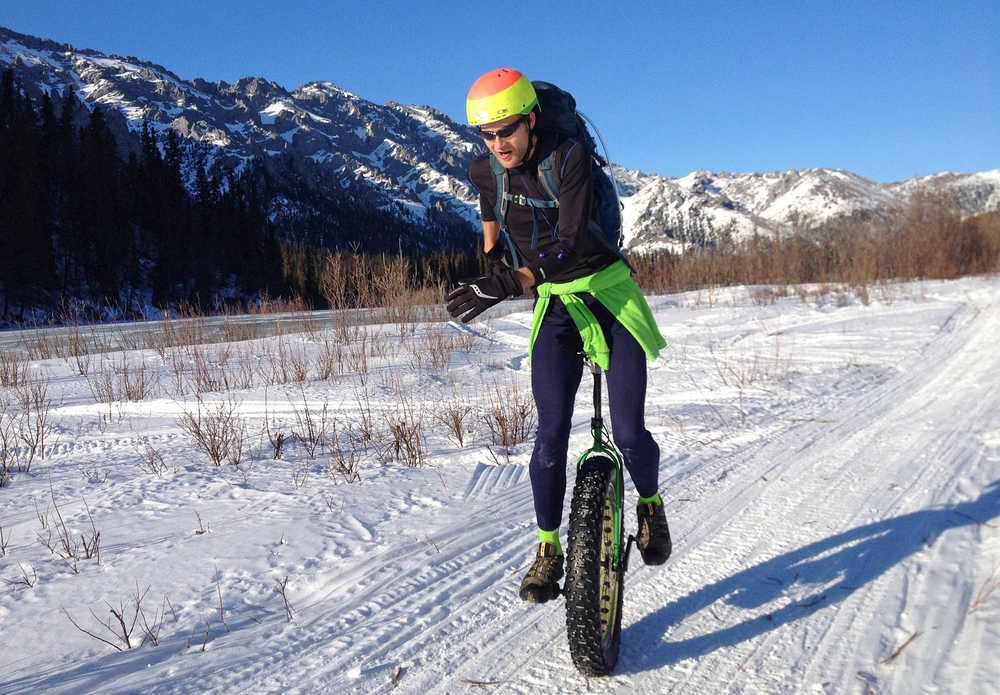 In this photo taken Sunday, March 30, 2014 and provided by Ed Plumb, unicyclist Elliott Wilson leaves a checkpoint during the White Mountains 100-mile ultra-marathon, north of Fairbanks, Alaska. When Wilson decided to ride a unicycle in the White Mountains 100 endurance race, he knew it was an off-the-wall idea. After all, most people wouldn't think about riding 100 miles on snowmachine and dog mushing trails in late March in Fairbanks on two wheels, much less one. Wilson succeeded, much to the surprise of himself, as well as some of Fairbanks' foremost two wheelers. (AP Photo/Ed Plumb)