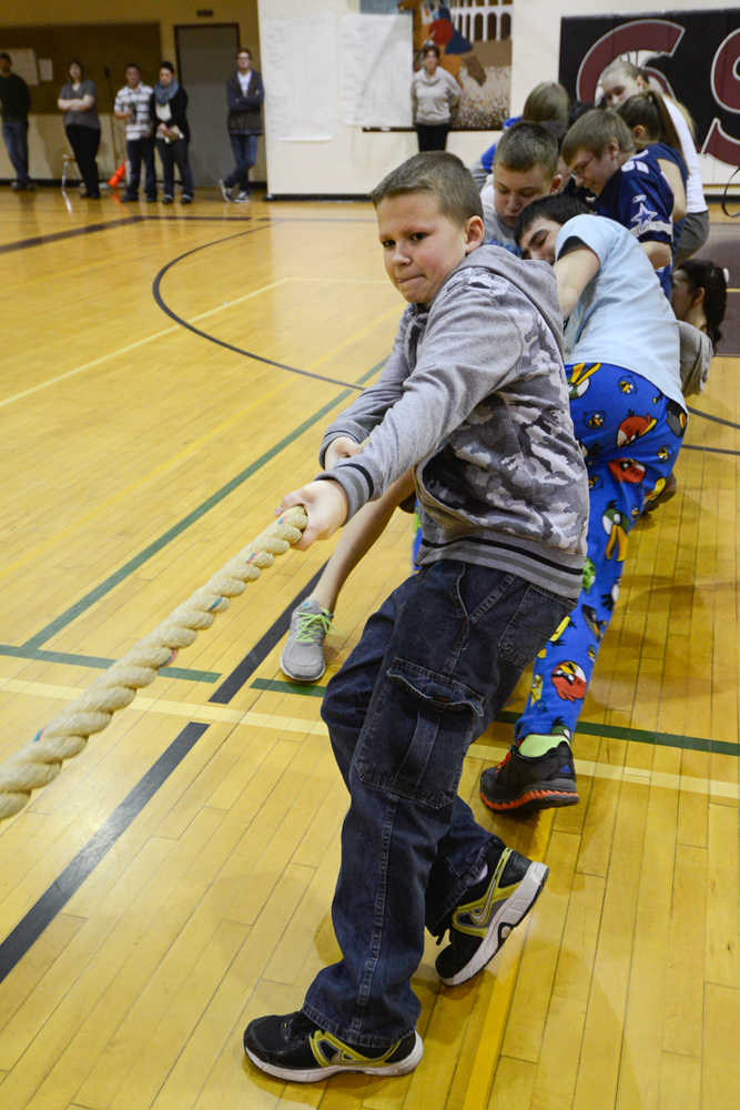 Photo by Rashah McChesney/Peninsula Clarion  Joseph Hensley, 14, takes the front of the line during a school-wide tug-of-war competition at Soldotna Middle School Thursday April 3, 2014 in Soldotna, Alaska.