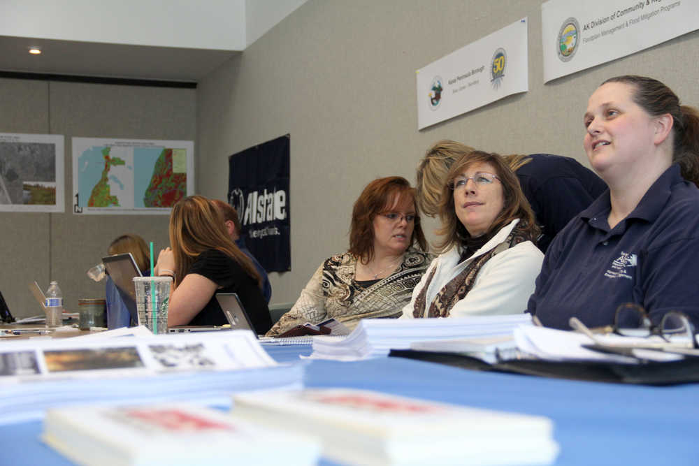 Photo by Kaylee Osowski Peninsula Clarion Rebecca Lopez (far right), Individual Assistance Branch Chief with the Division of Homeland Security and Emergency Management, along with representatives from other state and Kenai Peninsula Borough agencies wait to answer questions from people affect by central peninsula flooding at the borough sponsored Flood Aware Fair on Friday at the Donald E. Gilman River Center in Soldotna.