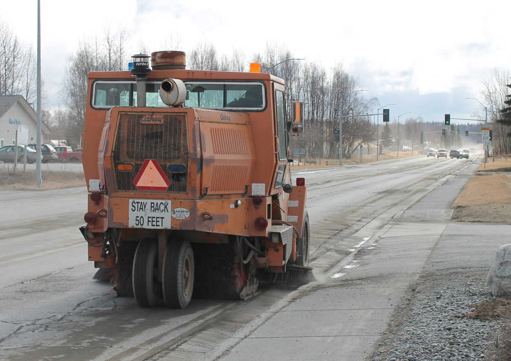A City of Soldotna street sweeper works along Binkley Street Monday afternoon. While area maintenance crews are out cleaning up this winter's road sand, forecasters are calling for a chance of snow today.