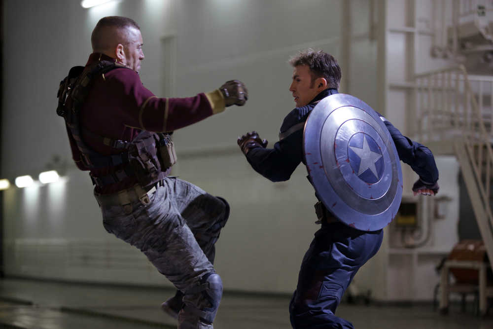 This image released by Marvel shows George St-Pierre, left, and Chris Evans in a scene from "Captain America: The Winter Soldier." (AP Photo/Marvel-Disney, Zade Rosenthal)