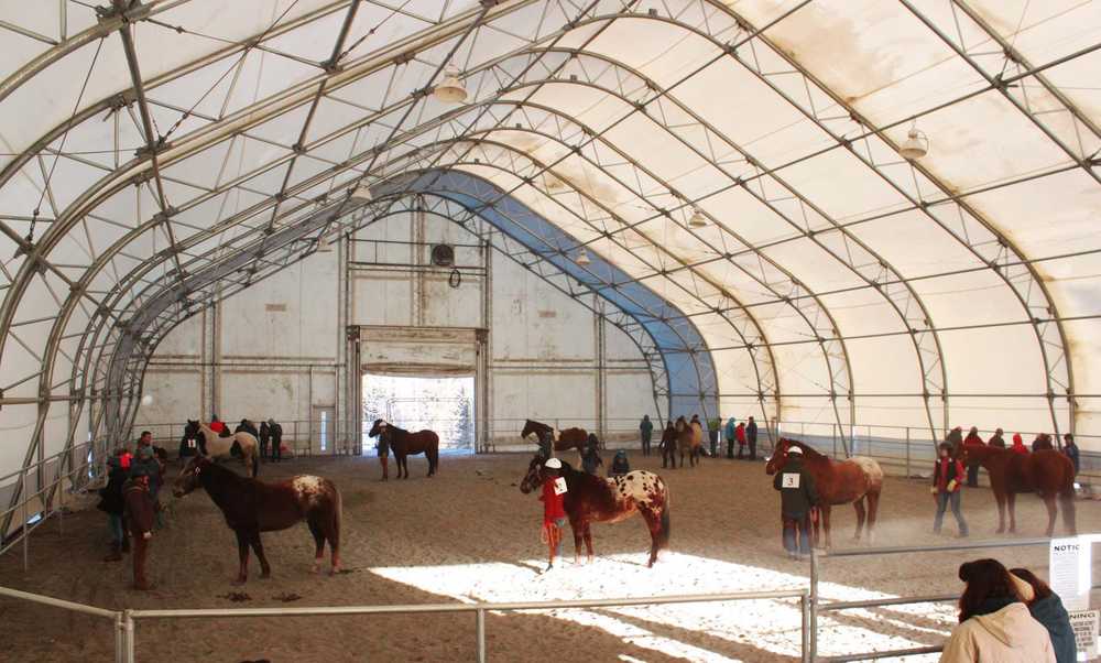 Photo by Kelly Sullivan/ Peninsula Clarion Horses are lined up behind participants who are asked to face the wall until the all the animals are situated correctly, Friday, April 11, at the Solid Rock Bible Camp.