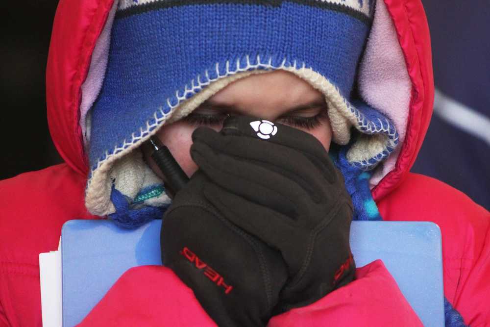 Photo by Kelly Sullivan/ Peninsula Clarion Cristiana Moyer, 11, warms her takes a moment to warm her hands, one of many 4H's struggling with the cold at the AH Horse Contest, Friday, April 11, at the Solid Rock Bible Camp.