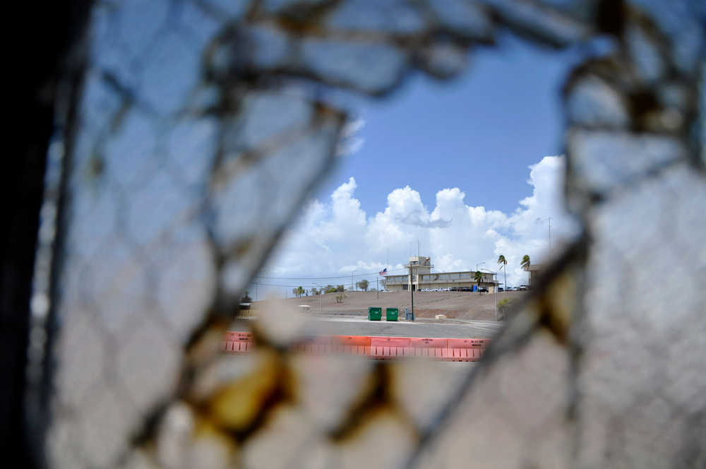 FILE - In this Aug. 23, 2013 pool file photo reviewed by the U.S. Department of Defense, one of Guantanamo Bay's two courthouses is seen through a broken window at Camp Justice at the Guantanamo Bay U.S. Naval Base, Cuba. On Monday, April 14, 2014 a judge in Guantanamo will open a hearing into the sanity of prisoner Ramzi Binalshibh, whose courtroom outbursts about alleged mistreatment in Camp 7 have halted the effort to try five men in the Sept. 11 attacks, all of whom are held there. (AP Photo/Toronto Star, Michelle Shephard, Pool, File)