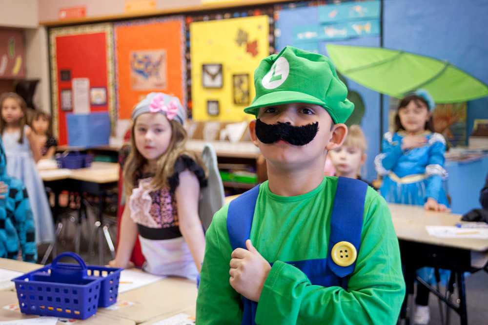 Photo by Rashah McChesney/Peninsula Clarion  Jayden Rodgers-Whipple, dressed as video game character Luigi, prepares to recite the Pledge of Allegiance Wednesday April 16, 2014 at Mountain View Elementary school in Kenai, Alaska. Students dressed up for "Character Day" at the school.