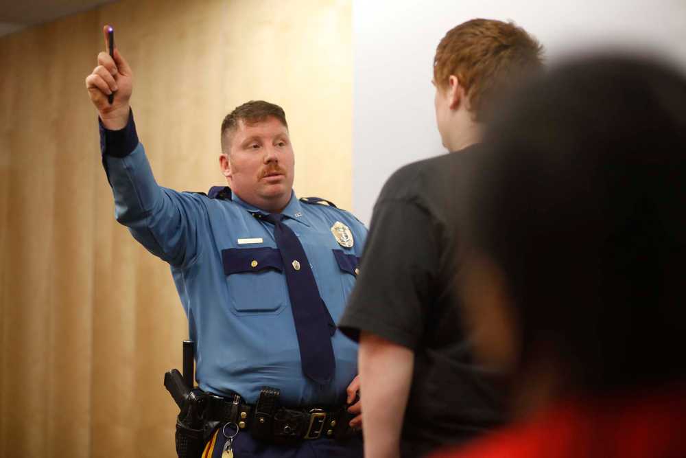 Photo by Kelly Sullivan/ Peninsula Clarion Officer Ronnie Simons gives resident Zach Moore a fake sobriety test during the Drunk Goggles presentation, Thursday, April 17, at the KPC Residence Hall.