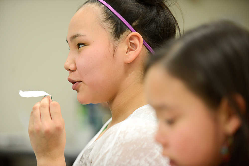 Photo by Rashah McChesney/Peninsula Clarion  Angelique Lincoln, 12, practices some of the Yup'ik language fricatives by shaping her mouth and blowing over a small piece of paper during a conversational Yup'ik class at the Kenai Peninsula College, Kenai River Campus Tuesday April 15, 2014 in Soldotna, Alaska.