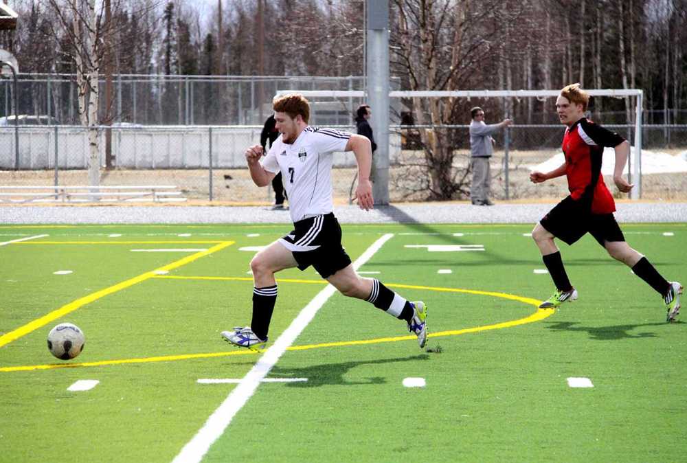 Nikiski's Christian Riddall follows the ball into the box after beating the final Houston defender and the Hawks goalkeeper who left the box to challenge the play. Riddall scored on the play to give the Bulldogs a 1-0 lead. Nikiski won the match 4-0.