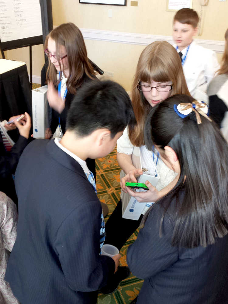 Photo courtesy of John DeVolld Soldotna Montessori Charter School sixth grader Shannon McClure works with students from other countries at the Montessori Model United Nations conference in New York City.