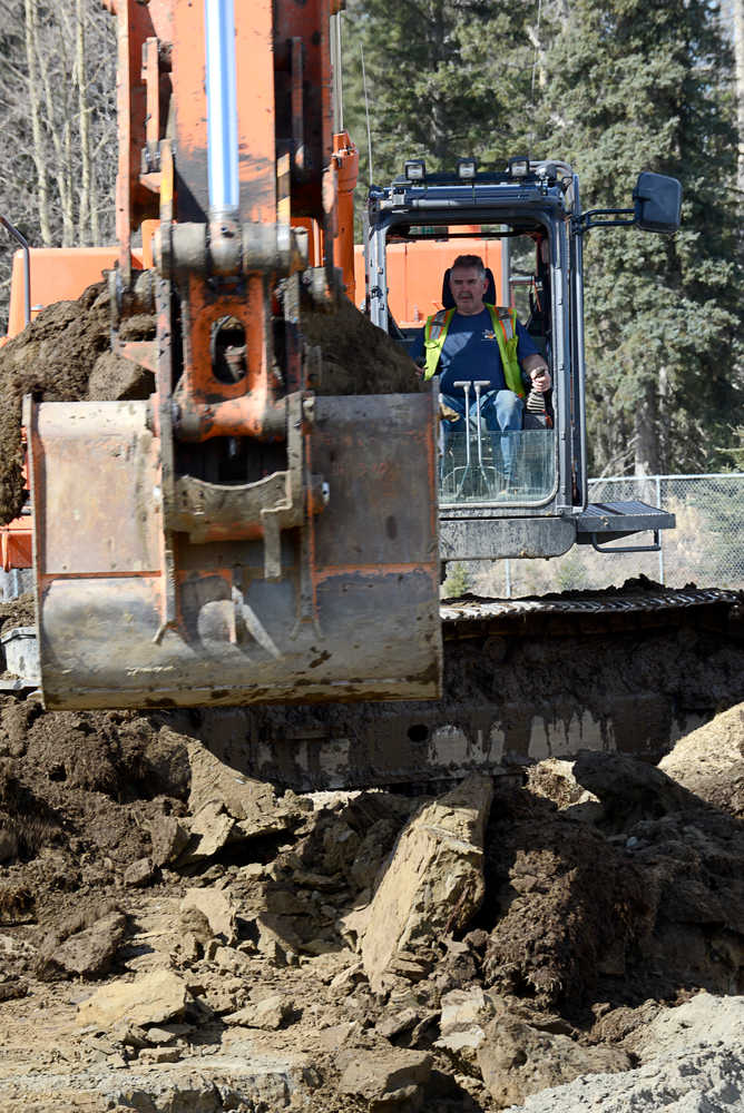 Photo by Rashah McChesney/Peninsula Clarion  Pat Heraghty operates an excavator for South Central Construction, Inc., a Soldotna company that is working on the field at Soldotna High School Tuesday April 22, 2014 in Soldotna, Alaska.