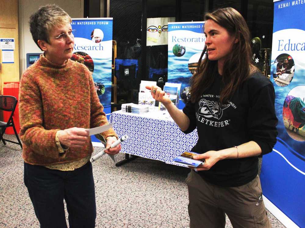 Photo by Kelly Sullivan/ Peninsula Clarion Kaitlin Vadla (right) talks to Mary Ann Dyke about Cook Inletkeeper at the Kenai Peninsula College's Earthday celebration, Tuesday, April 22, at KRC.