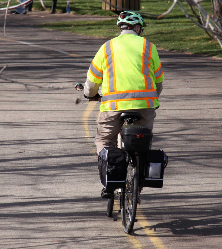 ADVANCE FOR TEH WEEKEND OF APRIL 19-20 AND THEREAFTER - Reflective clothing, lights and other gear make for a safe bicycle commute for a bicyclist in Boise, Idaho, in this April, 2014, photo.  Making yourself highly visible is one of many safety tips for bike commuters. (AP Photo/Idaho Statesman, Pete Zimowsky)