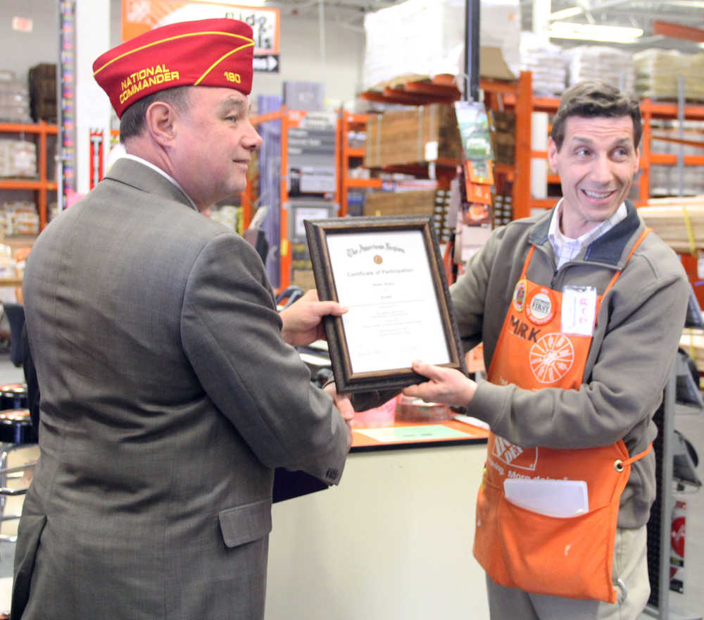 Photo by Dan Balmer/Peninsula Clarion American Legion National Commander Daniel Dillinger presents Kenai Home Depot store manager Mark Pierson with a certificate of appreciation for the store's honor of veterans with a reserved parking space.