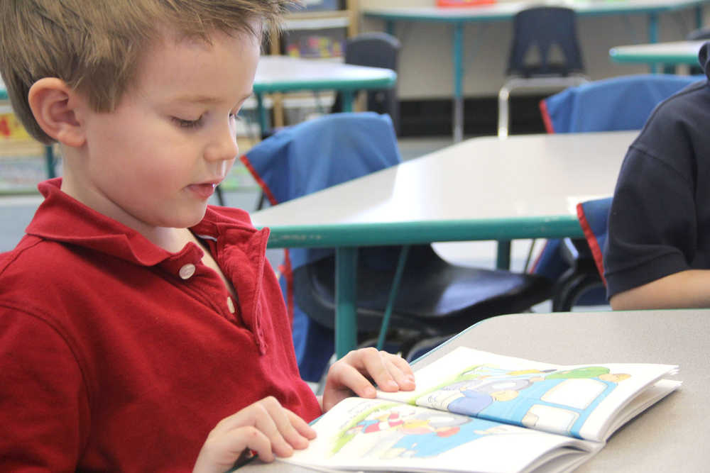 Aurora Borealis Charter School kindergartener Peyton Kindred reads out loud with his reading group at school on April 15 in Kenai. Photo by Kaylee Osowski/Peninsula Clarion