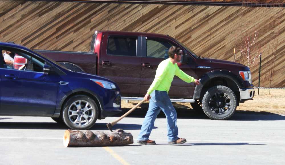 Photo by Kelly Sullivan/ Peninsula Clarion Adam McKenzie helps during clean up for Construction Career Day, Tuesday, April 29, at the Soldotna Sports Center.