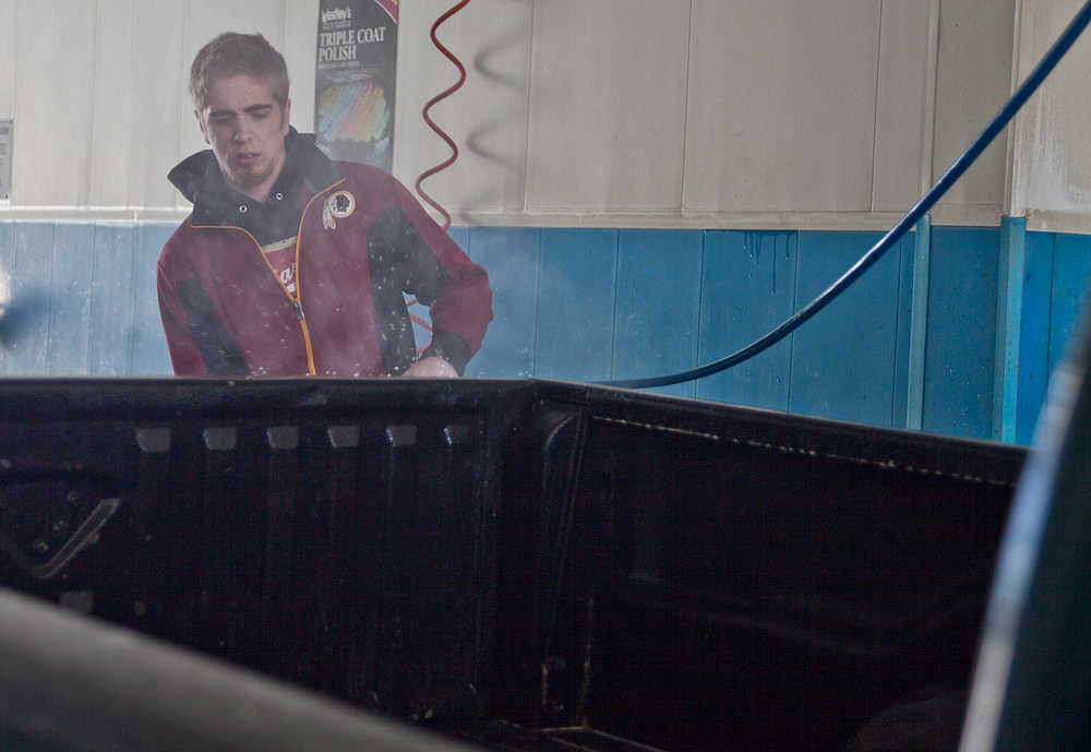 Photo by Rashah McChesney/Peninsula Clarion Jordan McNamara, of Nikiski, washes his truck Tuesday April 29, 2014 in Soldotna, Alaska.