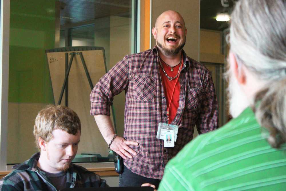 Photo by Kelly Sullivan/ Peninsula Clarion Scott Sellers helped Steve Vinzant and Carl Hatten hook up a power cord during a study session, Tuesday, April 29, at the Kenai Peninsula College Residence Hall.