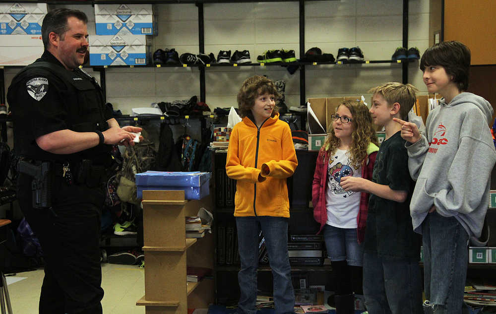 Photo by Dan Balmer/Peninsula Clarion Soldotna Police Officer Tobin Brennan quizzes Kelsey Beaudin, Alexis Gomes, David Schramm and Logan Steiner DARE questions in Jake Eveland's fifth grade class at Redoubt Elementary School in Soldotna Wednesday.