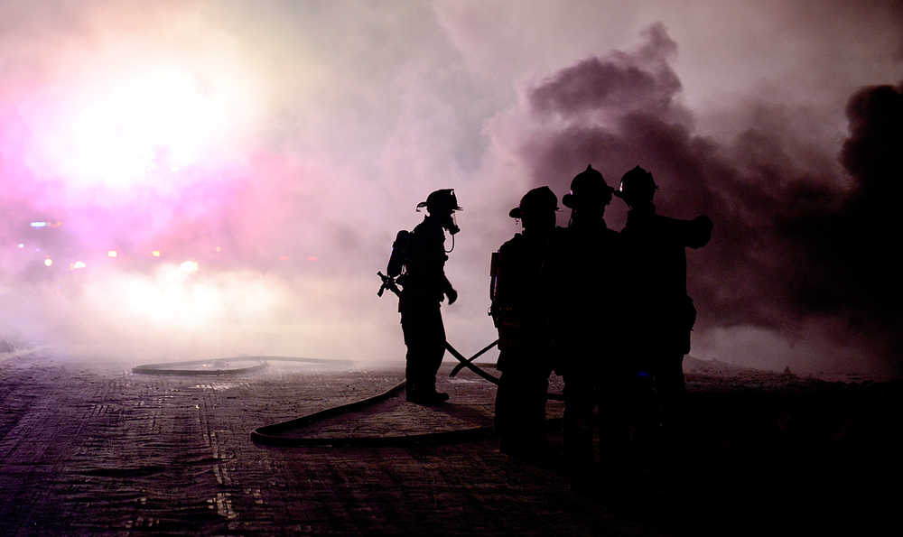 Clarion file photo  Smoke and steam obscure firefighters as they work to extinguish a fire that consumed two homes Thursday Dec. 20, 2014 in Soldotna, Alaska.