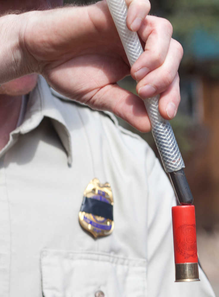 Photo by Rashah McChesney/Peninsula Clarion Dave Bolin, refuge operations specialist at the Alaska Martitime National Wildlife Refuge, uses a tool to check the contents of a shotgun shell Saturday May 3, 2014 during a Youth Game Warden camp at the Kenai National Wildlife Refuge headquarters in Soldotna, Alaska.