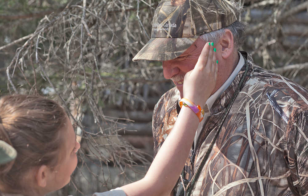 Photo by Rashah McChesney/Peninsula Clarion  Dana Gibson brushes a mosquito off of Andy Loranger, Refuge Manager at the Kenai Wildlife Refuge, Saturday May 3, 2014 during a Youth Game Warden Camp at the refuge headquarters in Soldotna, Alaska.