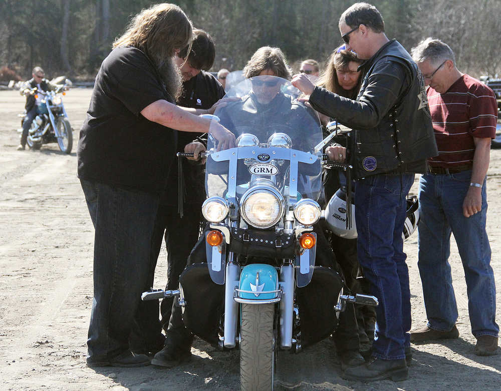 Photo by Dan Balmer/Peninsula Clarion Greg Matranga of Soldotna receives a prayer from Scott Hannan (left) and Gary Anderson (right) at a biker blessing at the Nikiski Church of the Nazarene Sunday. More than 40 bikers rode in from all over the Kenai Peninsula for the event.
