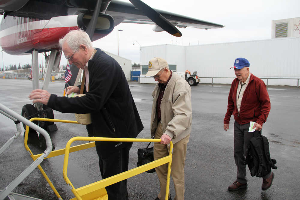 Photo by Dan Balmer/Peninsula Clarion Dick Weaver, Bud Gilbertson and Robert Harrison all of Nikiski board a flight to Anchorage Tuesday morning at the Kenai Municipal Airport. The men are part of a group of six World War II veterans from the Kenai Peninsula traveling to Washington D.C. with 50 other veterans from Alaska on the honor flight trip that takes veterans to visit WWII memorials.