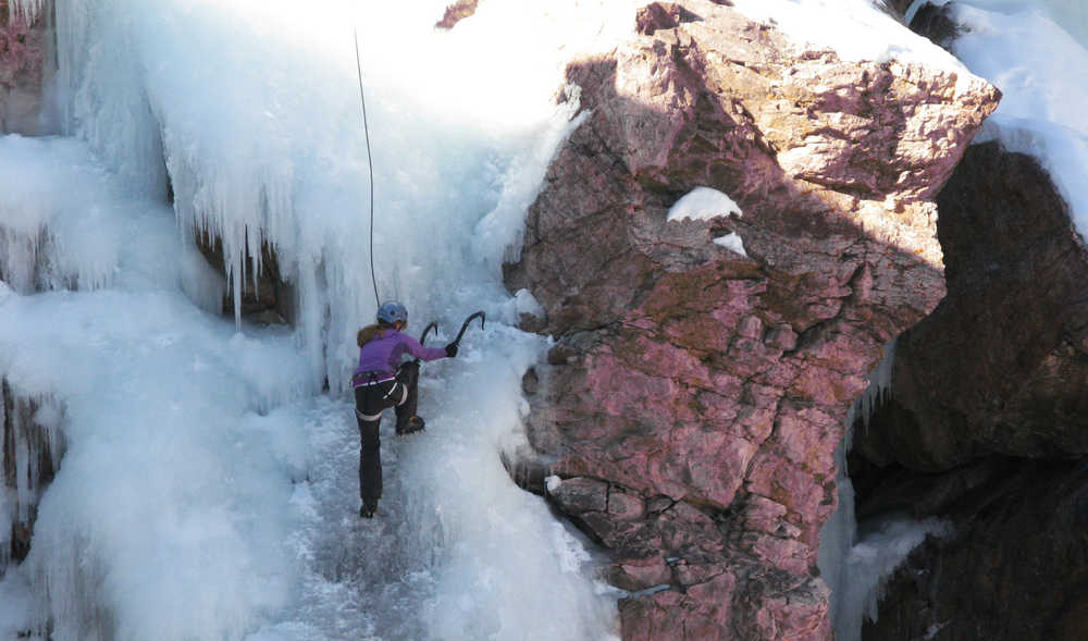 This Jan. 18, 2014 photo shows an unidentified climber making her way up the Ouray Ice Park in Ouray, Colo. Chicks with Picks, a company founded to introduce the sport of ice climbing to women, holds several clinics each winter in in the Ouray Ice Park,  a city-owned facility with man-made ice in a natural gorge. (AP Photo/Donna Bryson)