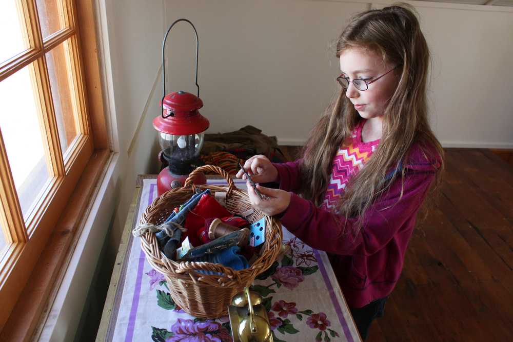 Photo by Kelly Sullivan/ Peninsula Clarion Marge Mullen told the students of Shaya Straw's third grade Soldotna Elementary School class tree stumps were used as chairs in old houses, Thursday, May 8, at the Soldotna Historic Post Office.