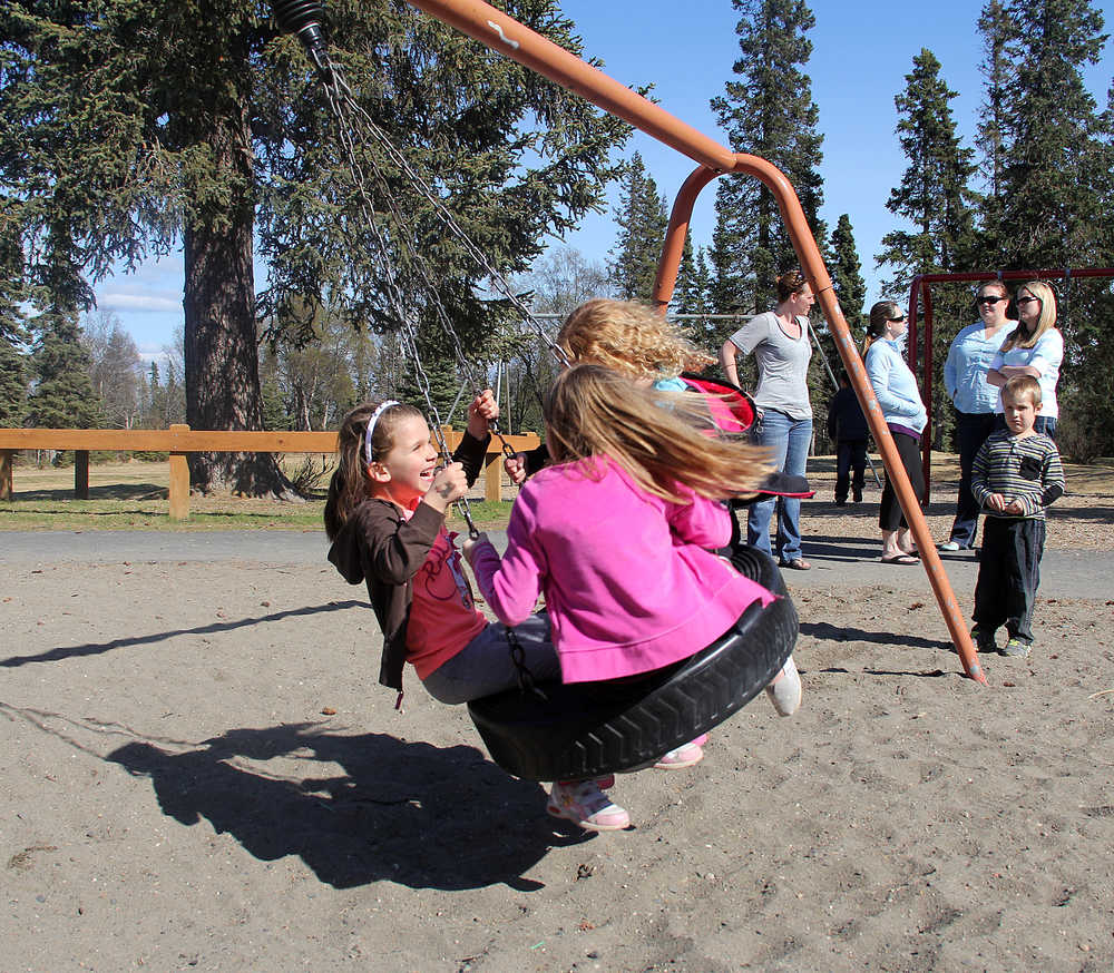 Photo by Dan Balmer/Peninsula Clarion Three girls swing while Cooper Every watches at Municipal Park Thursday. In the background, sisters Amber and Kristen Every along with Angie Cramer and Nicole Peterkin watch. The foursome who call themselves the Kenai moms, have been active in developing a proposal with the City of Kenai Parks and Recreation commission for two new playgrounds for both younger and older kids.